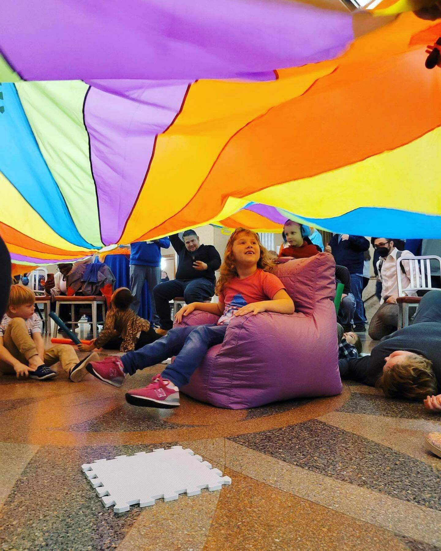 interior Smith Lobby with kids playing with a parachute and a girl in a purple beanbag chair
