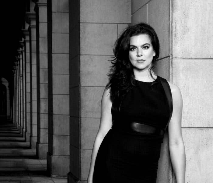 Ambur Braid standing near a wall