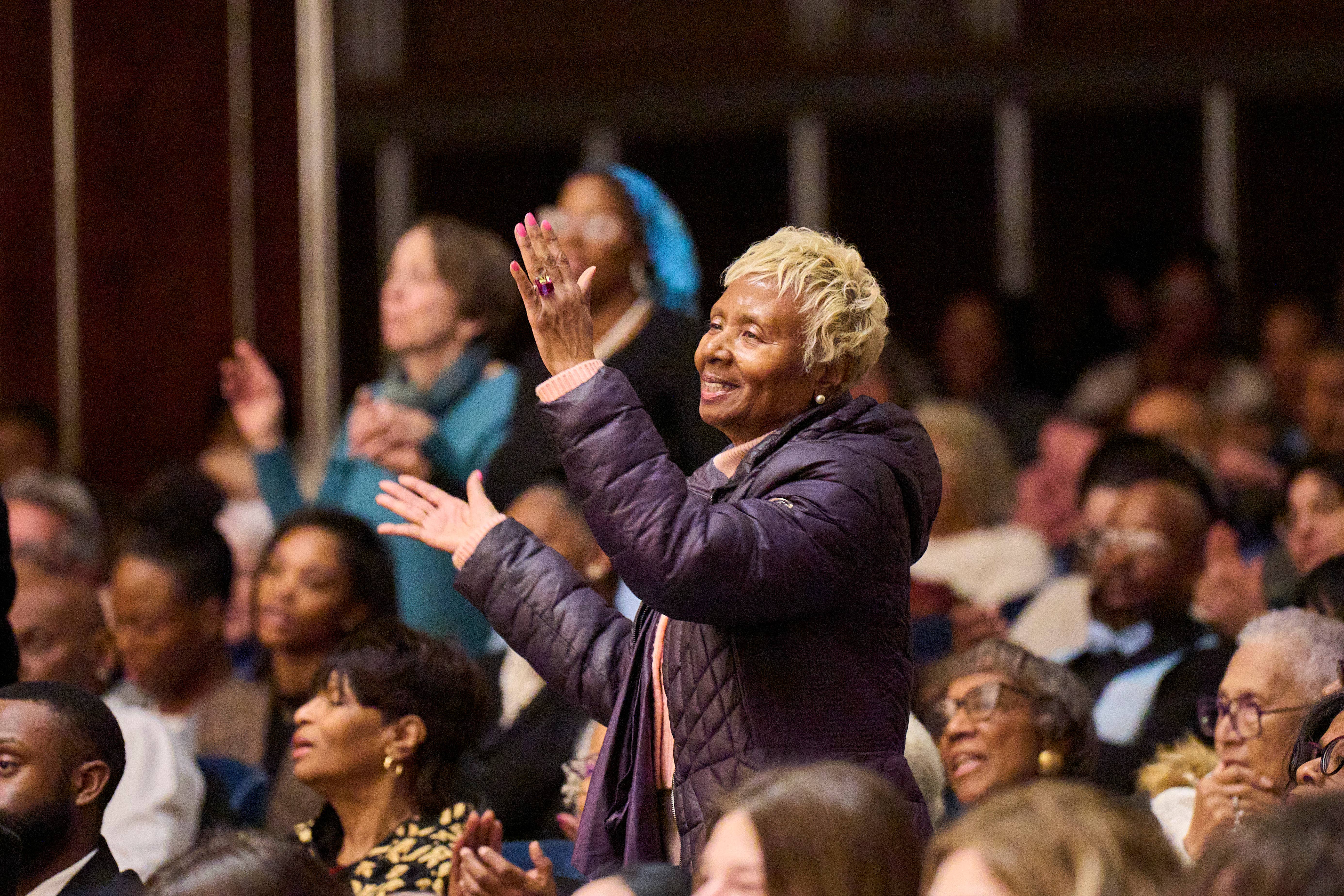 woman clapping in Mandel Hall orchestra level