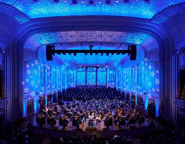 interior photo of Mandel Concert Hall with The Cleveland Orchestra and Chorus on stage with Sarah Hicks conducting Holiday concert