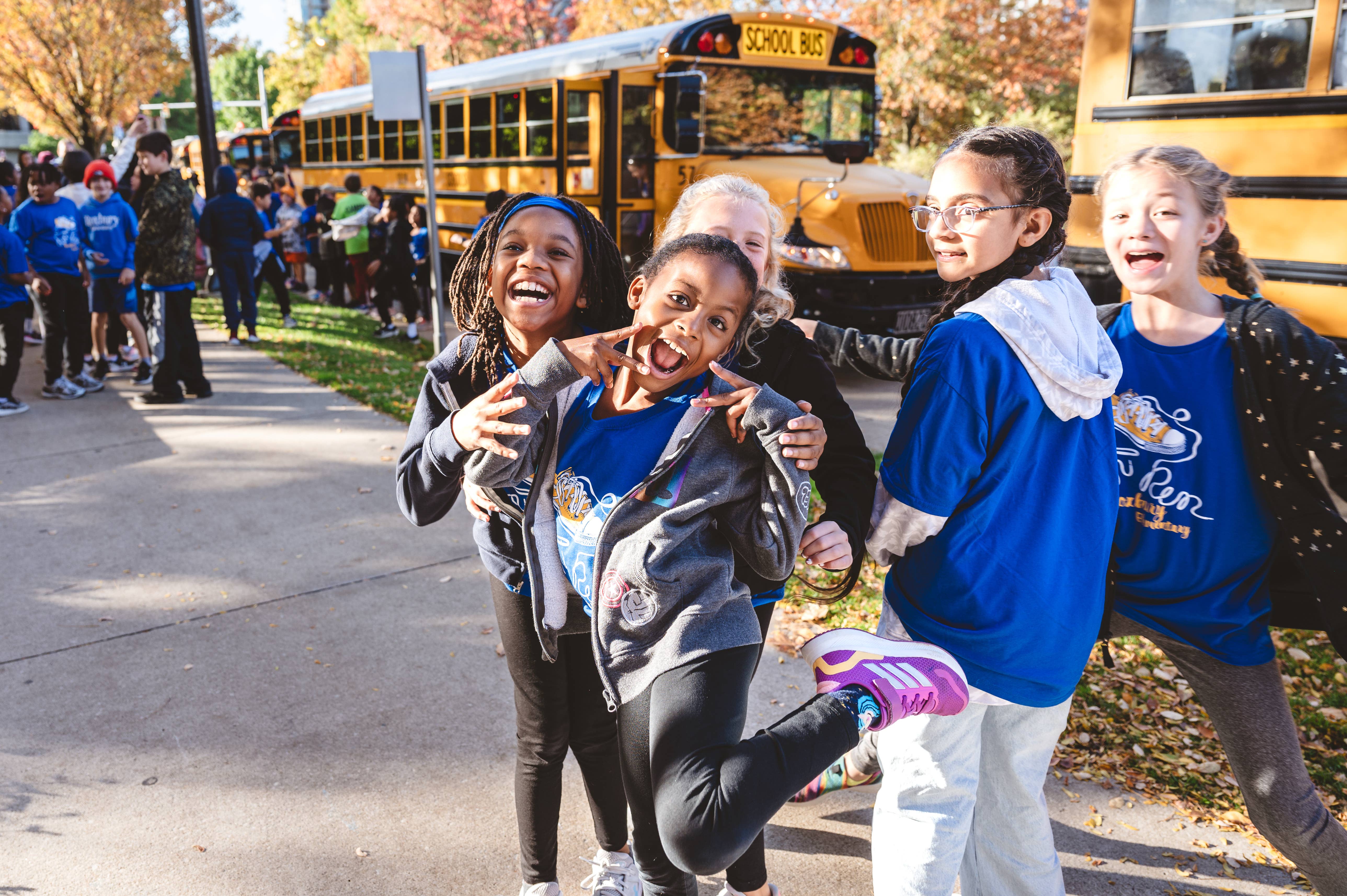 kids outside Severance Music Center with busses in the background