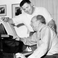 Harris (seated) playing piano with his former student George Lynn