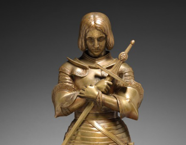 Bronze armored statue of a medieval knight holding a staff, with “The Cleveland Museum of Art” text and logo