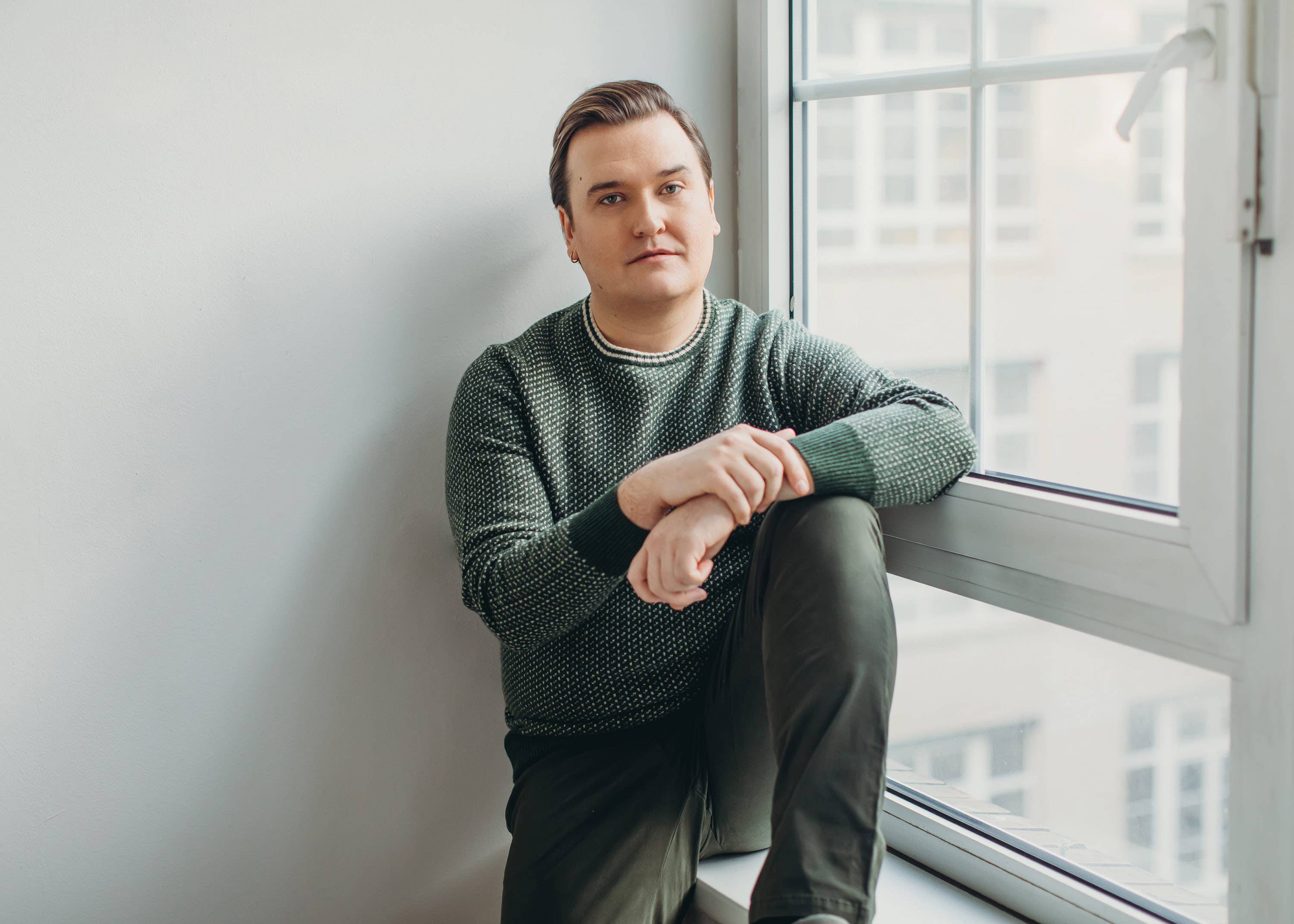 Miles sitting next to a window