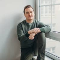 Miles sitting next to a window