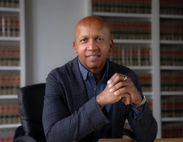 Bryan Stevenson in front of bookshelves
