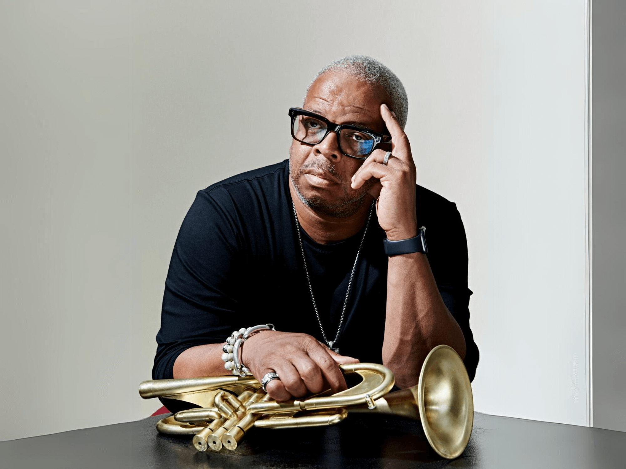 Terence Blanchard holding a trumpet against a light backdrop