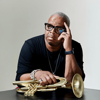 Terence Blanchard holding a trumpet against a light backdrop