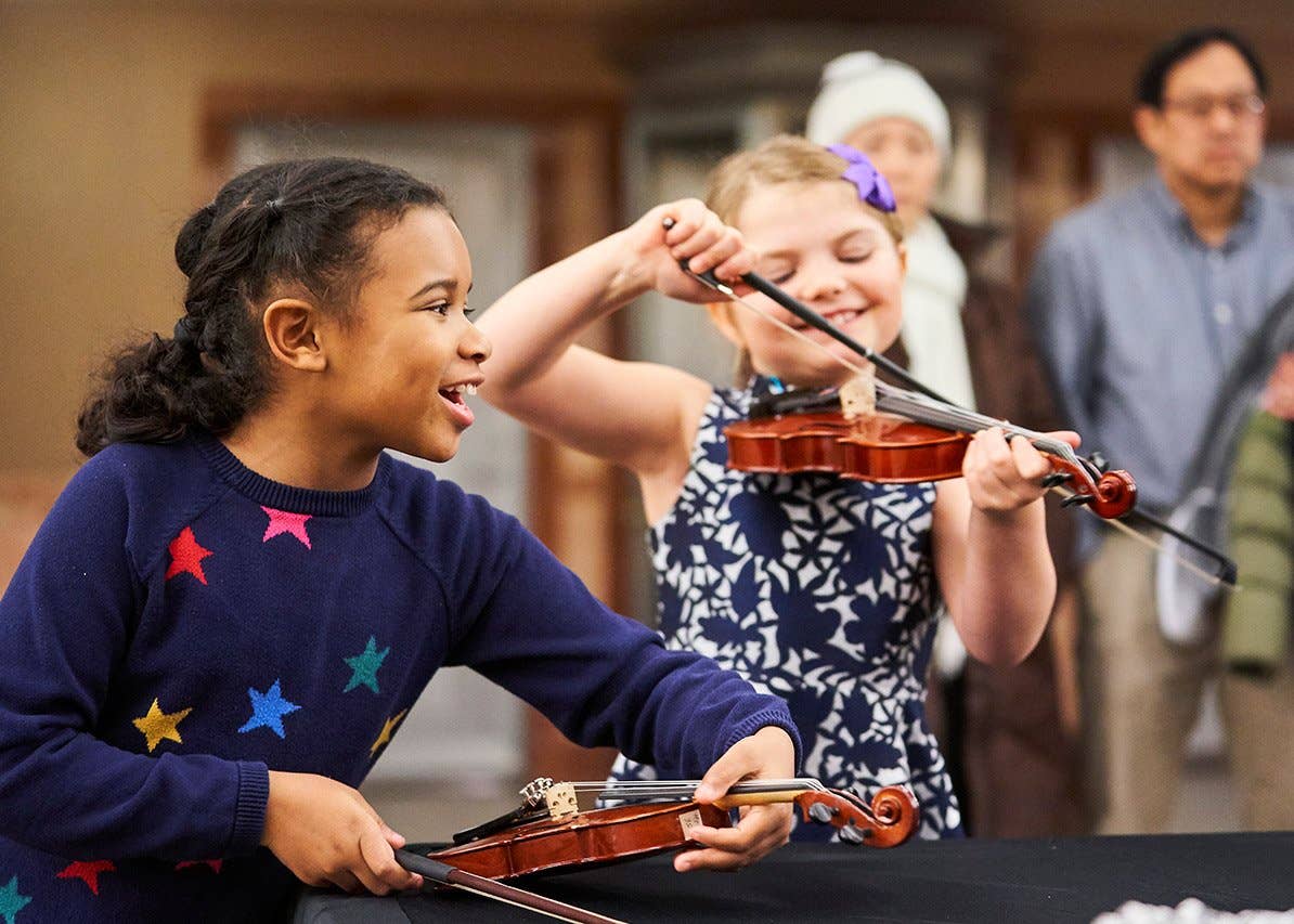 Children experimenting with instruments in Smith Lobby