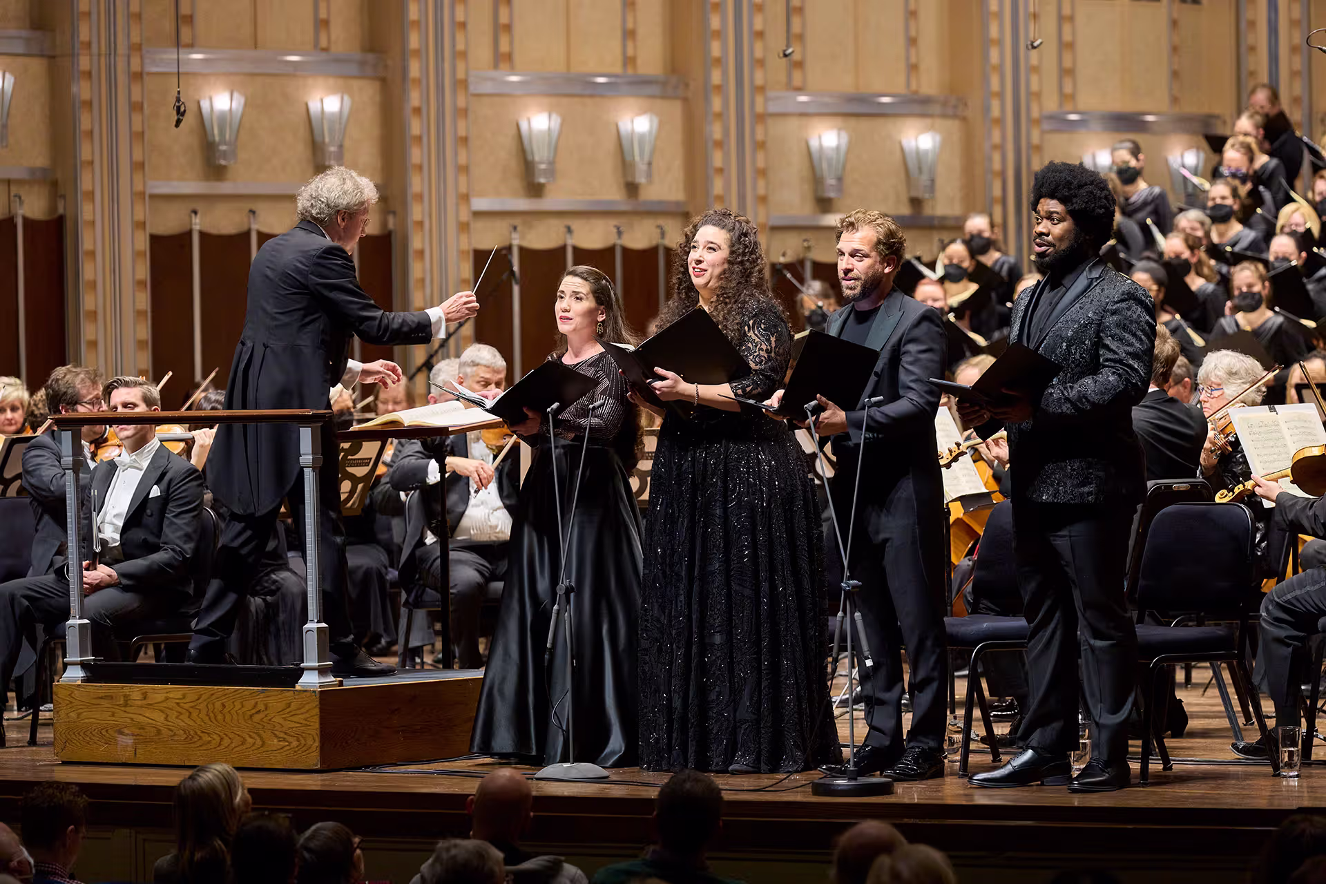 Franz directs individual singers in front of The Cleveland Orchestra