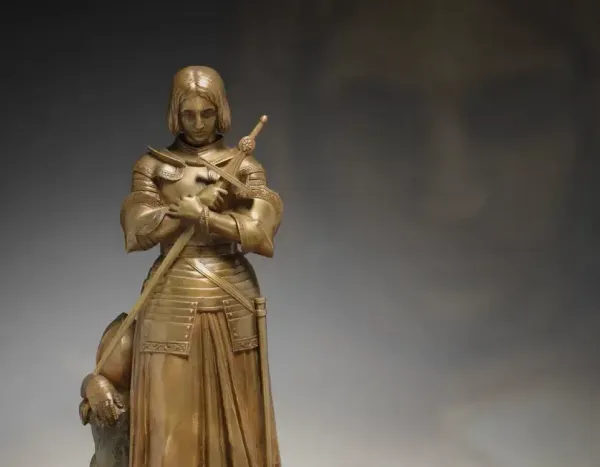 Bronze armored statue of a medieval knight holding a staff, with “The Cleveland Museum of Art” text and logo