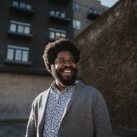 Dasha Burton standing near brick wall