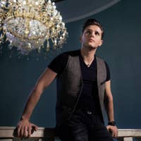 Iurii sitting in front of a light fixture