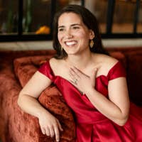 Joelle smiling in a red dress