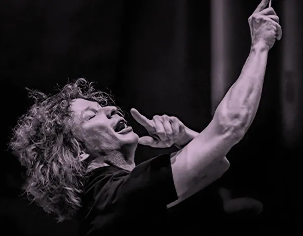Conductor, Santtu-Matias Rouvali, passionately leading an orchestra, with expressive gestures and focused expression.