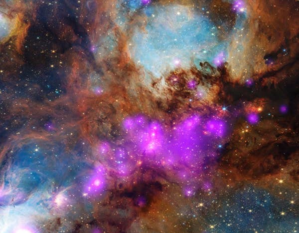 Vibrant colorful nebula with glowing stars and purple blue gas clouds across deep space
