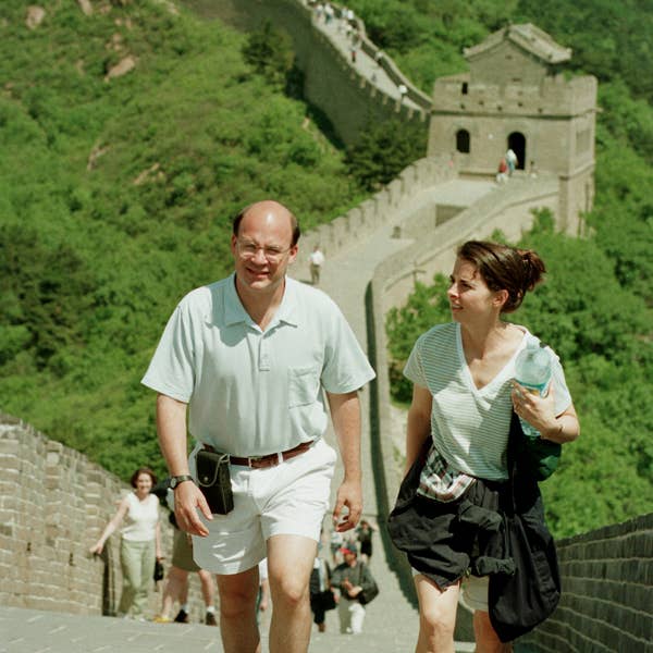 Orchestra musicians walk along the Great Wall of China while sightseeing during the 1998 tour.