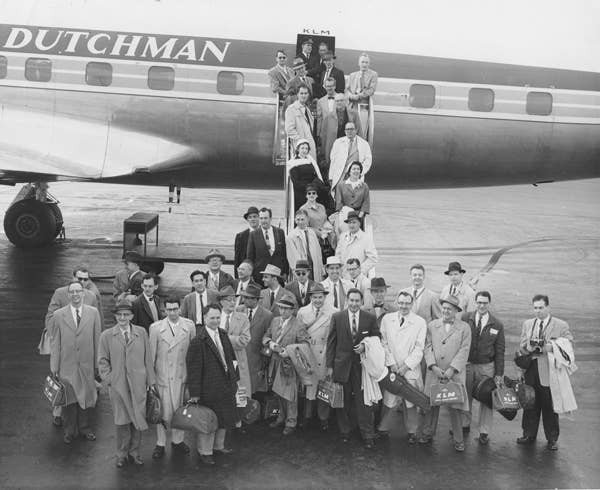 Members of the Orchestra pose by their plane on the way to Europe for the first time as an ensemble in 1957.