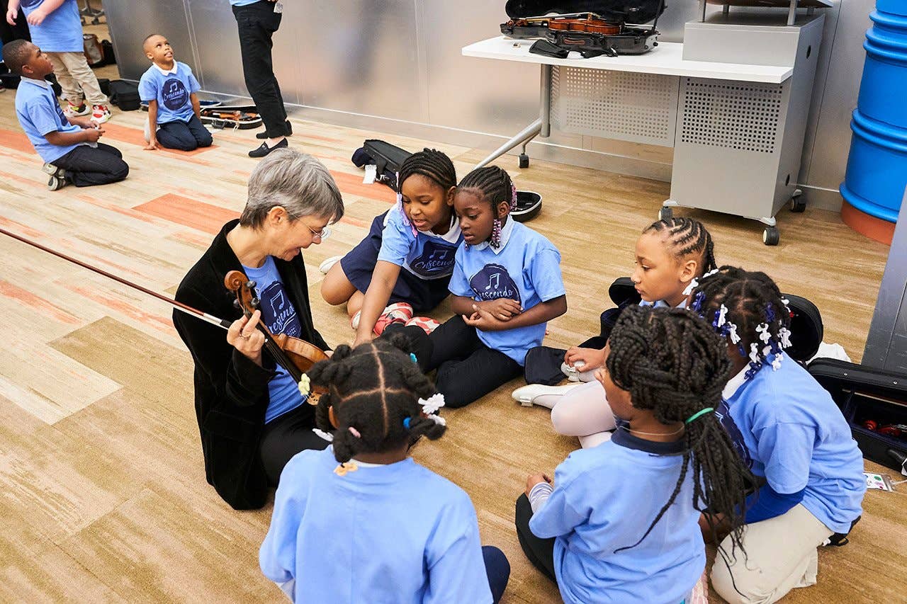 Crescendo program kids learning about the violin