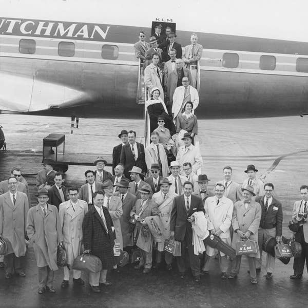 Members of the Orchestra pose by their plane on the way to Europe for the first time as an ensemble in 1957.