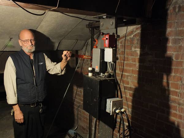Building engineer Scott Miller shows off the original 1931 mechanism for lifting it to its place of prominence (2015).