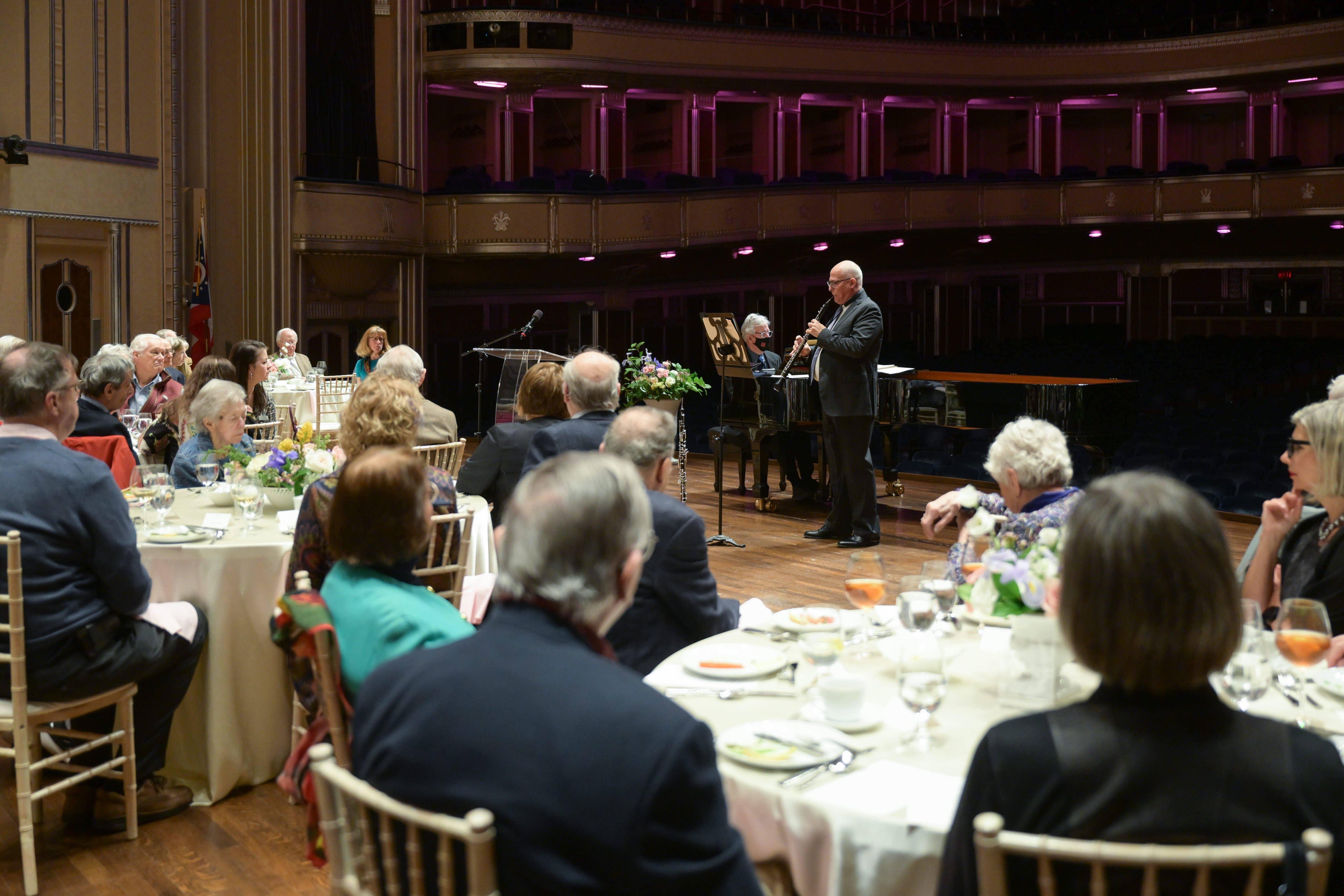 Members of Heritage Society eating on Mandel Concert Hall stage