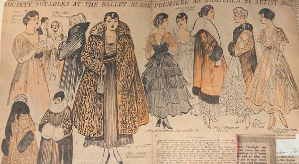 A newspaper depicts women in lavish black and orange coats.