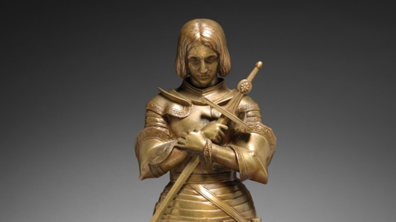 Bronze armored statue of a medieval knight holding a staff, with “The Cleveland Museum of Art” text and logo