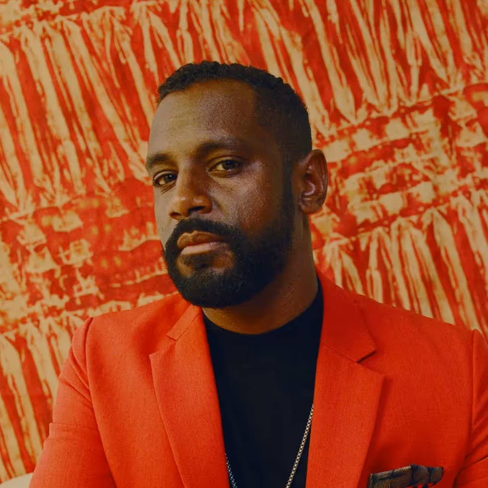 A bearded man in a red jacket