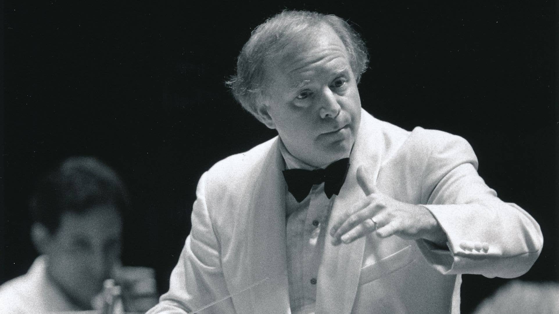 Leonard Slatkin conducting the Orchestra at Blossom Music Center. Slatkin and the Orchestra are dressed in white, which is formal dress for Blossom performances.