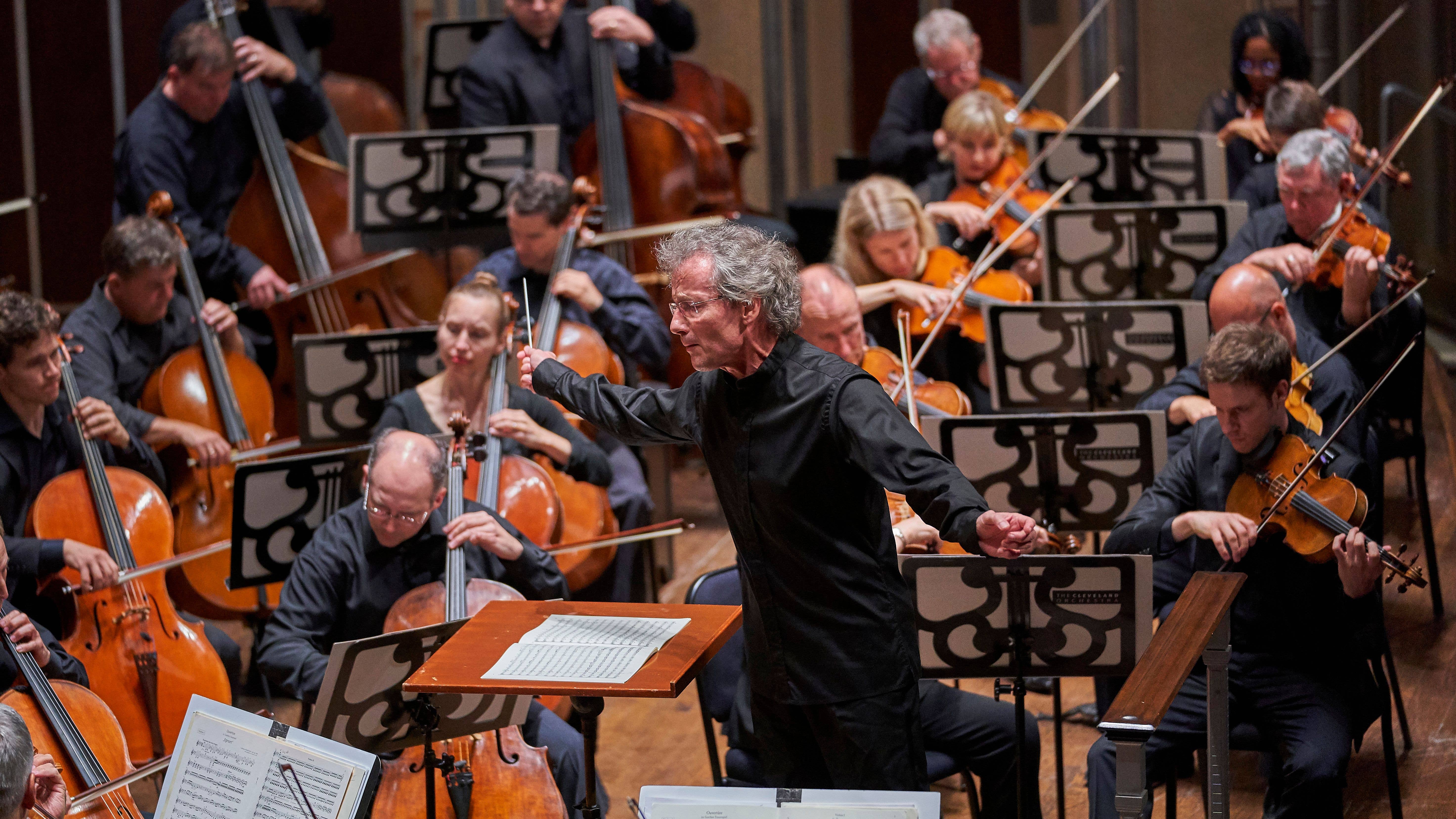 Franz is conducting the Orchestra. Franz and the Orchestra all look very intent.