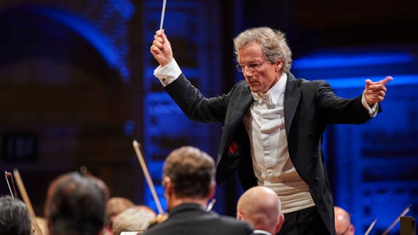 Franz Welser-Möst conducting The Cleveland Orchestra at the Maltz Performing Arts Center. He is gesturing to musicians in preparation for an important moment in the score.