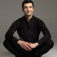 Jacob Joyce, conductor, featured seated