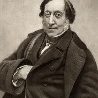 Sepia portrait of Gioachino-Rossini, wearing a bow tie, and a dark coat.