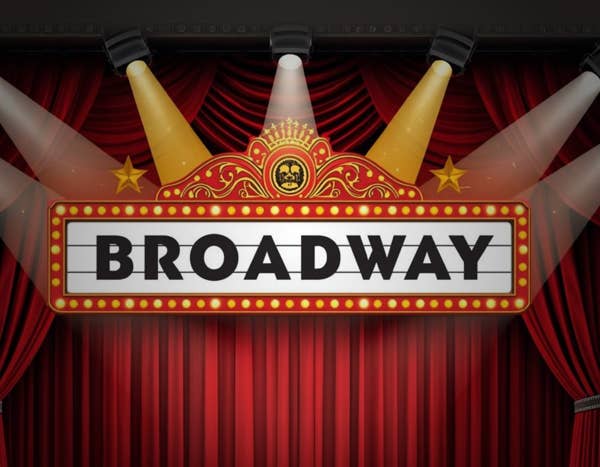Stage banner reading Broadway with gold drums, red curtains, and spotlight arcs overhead.