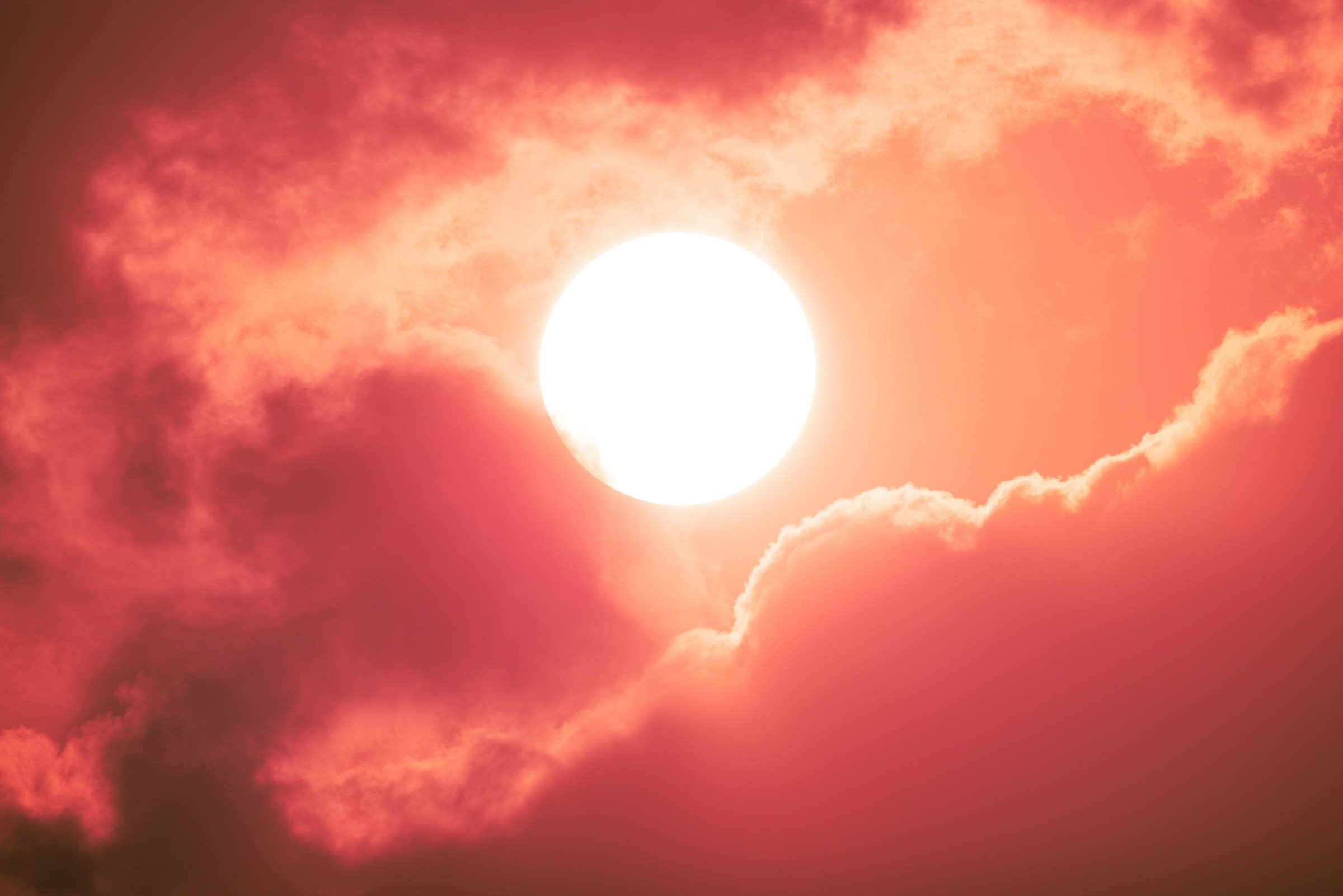 hot sun behind clouds