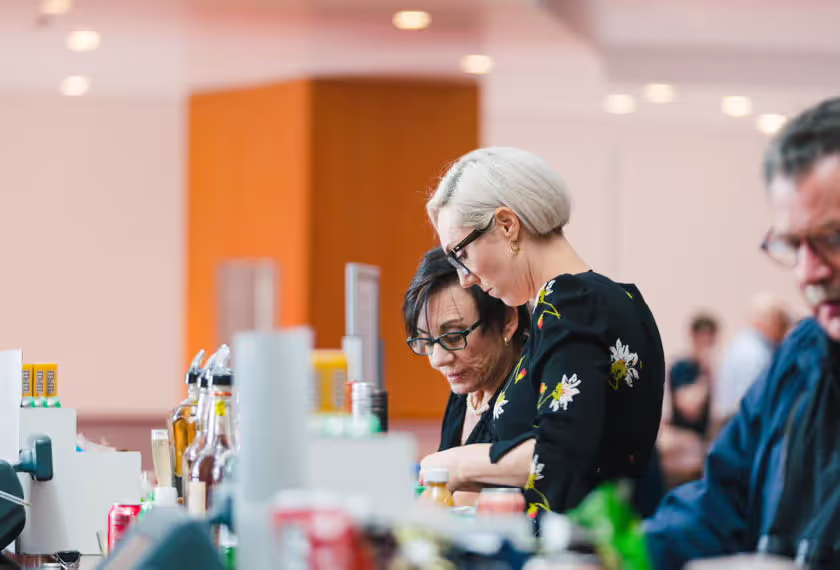 2 women getting snacks from a snack bar