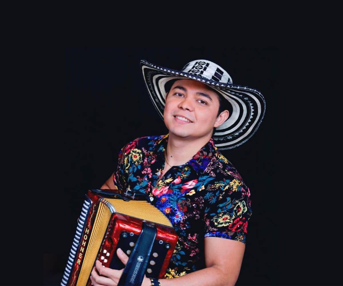 Yeison Landero holding an accordion. 