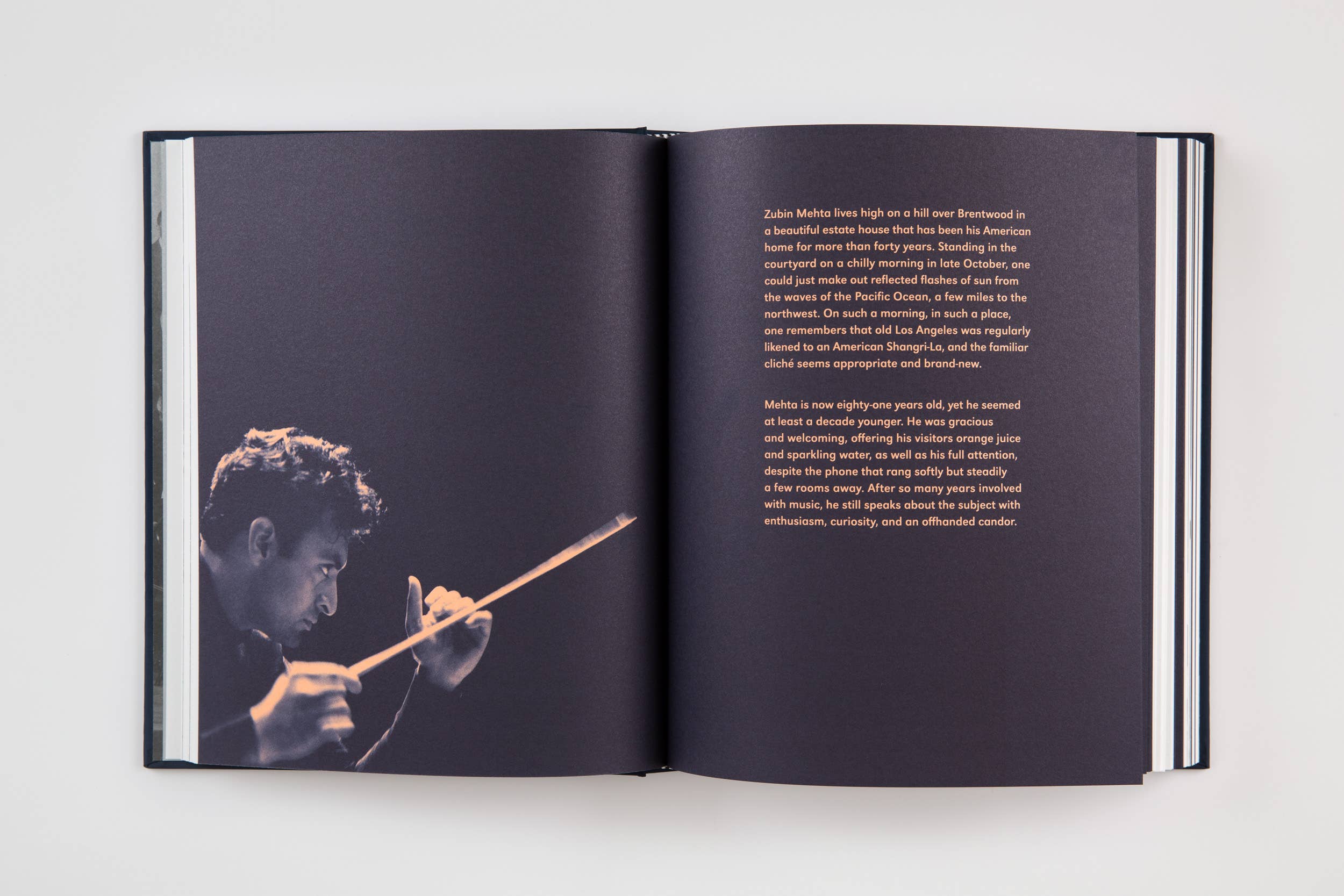 Open book spread with photo of a man holding a cigarette and a text paragraph on the right page.