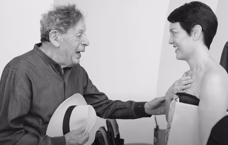 elderly gentleman with hat conversing with woman