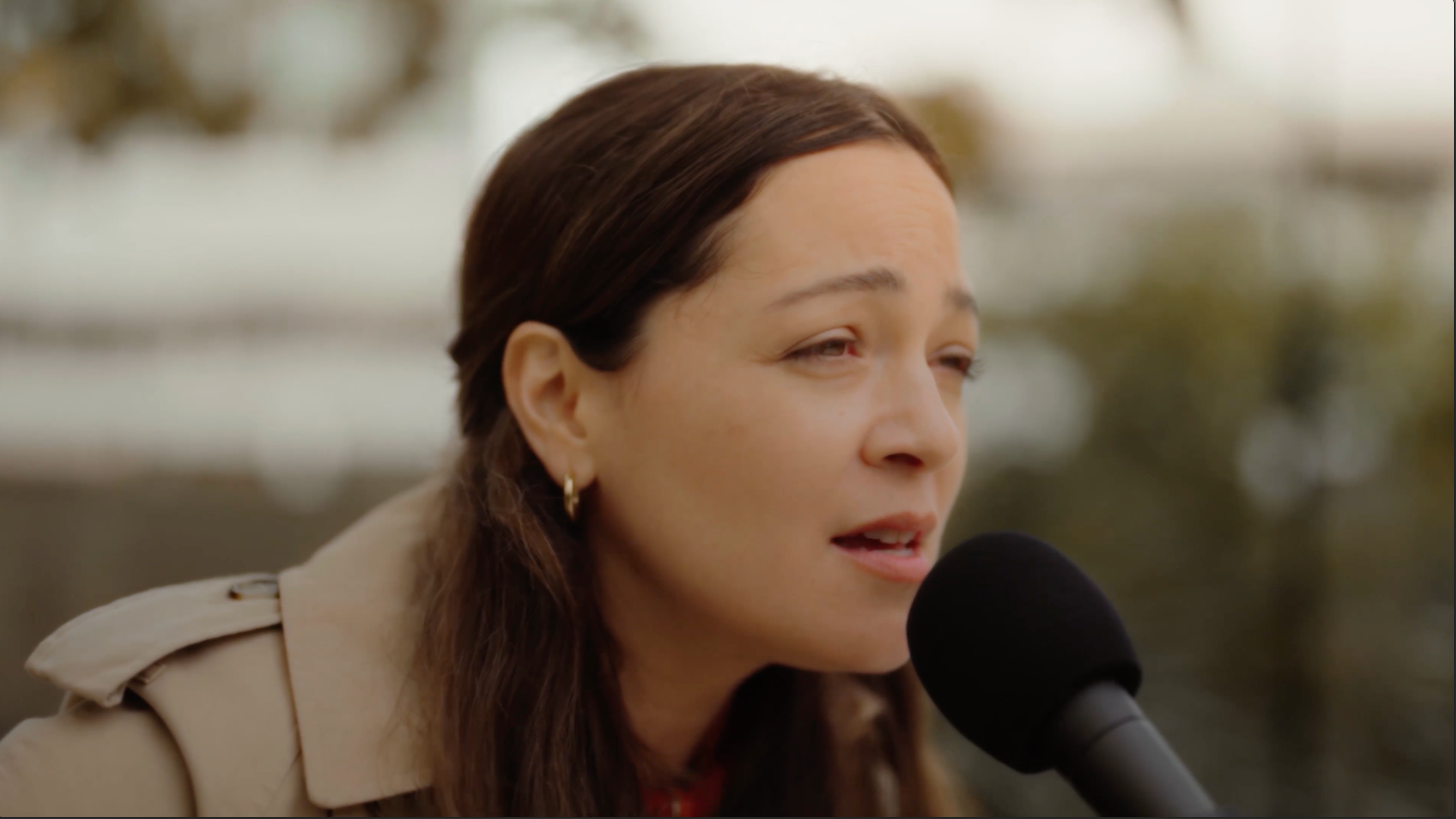 A video still of Natalia Lafourcade singing during a performance.