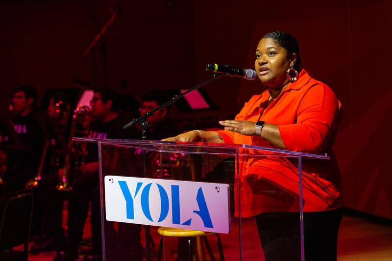 Camille Delaney-McNeil speaking at a YOLA event.
