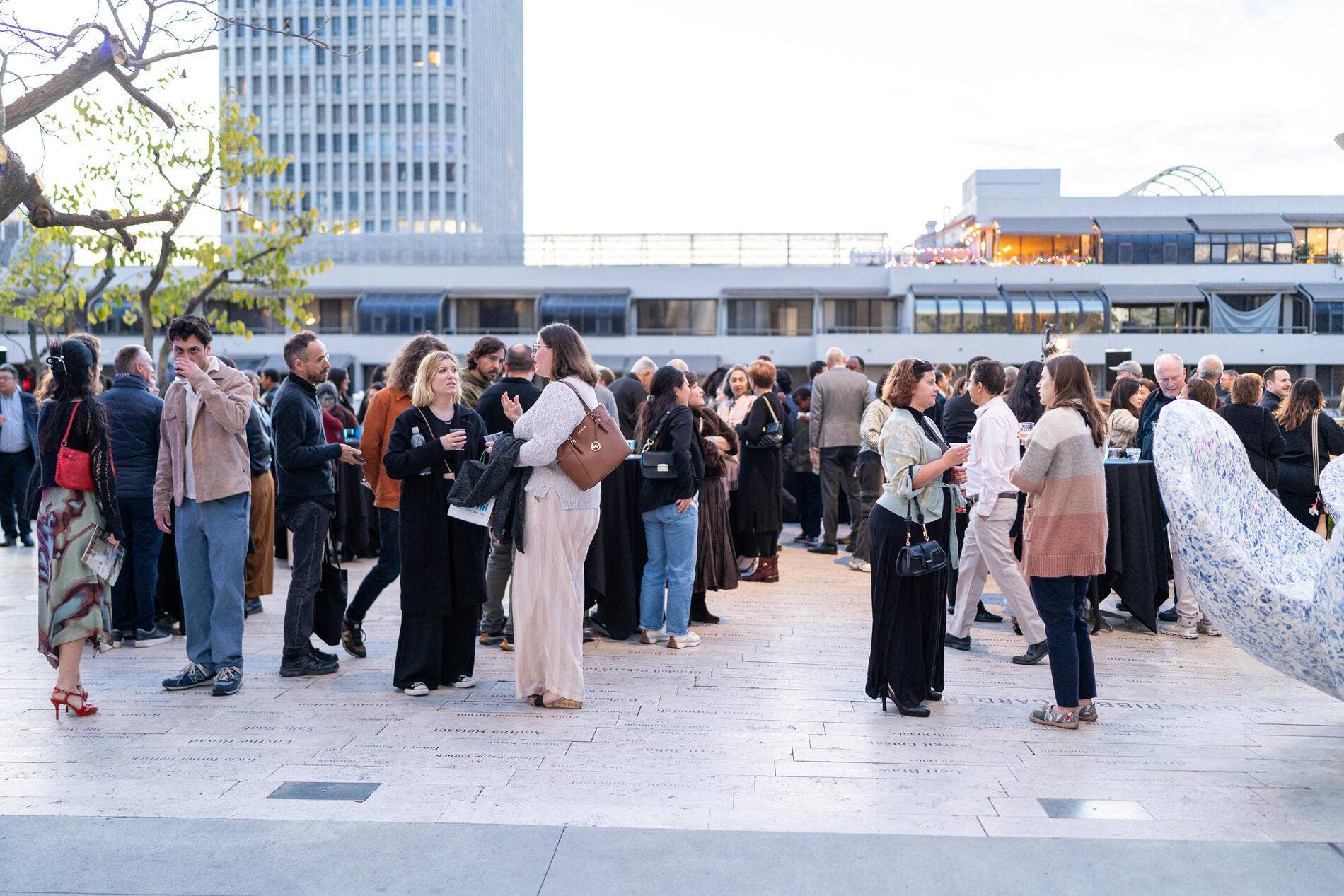Crowd of people outdoors at a Drinks in the Garden event