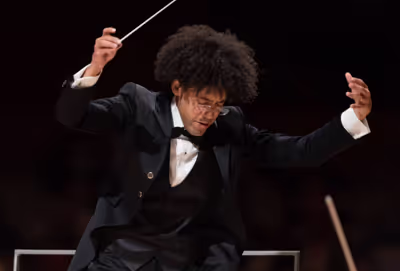 man in tuxedo conducts