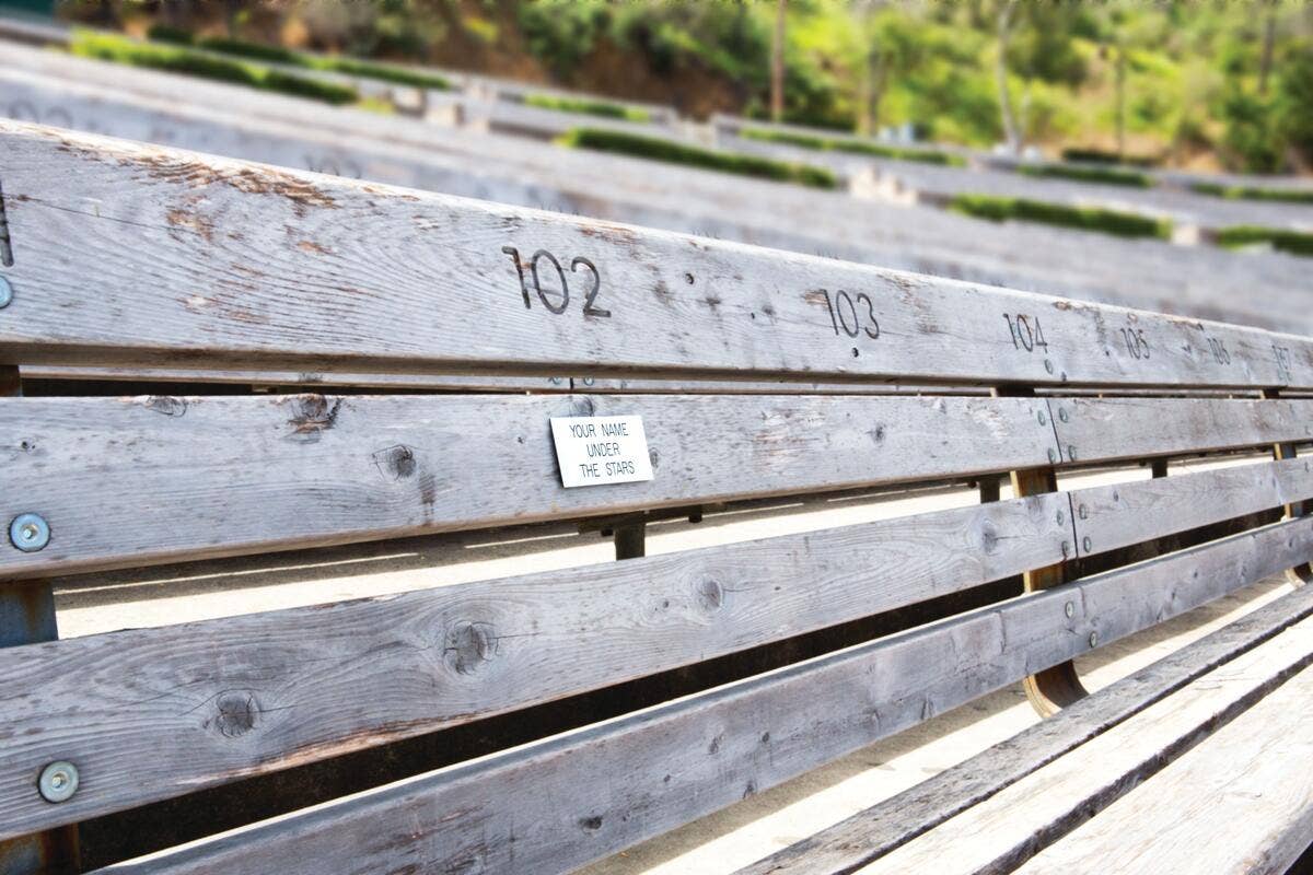 Close-up of numbered wooden storage shelves with a small sign reading your name under the stars