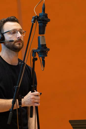 A Workforce Development Program participant sets up a microphone before a recording session.