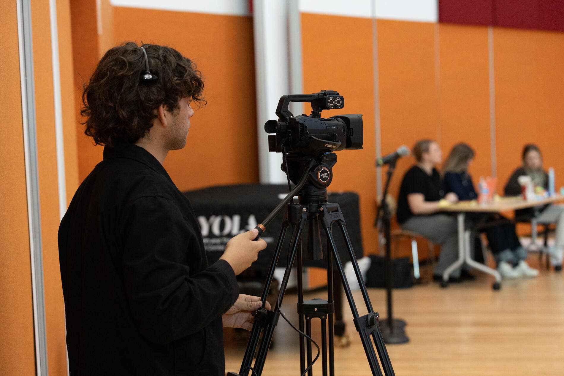 A WDP stagehand recording a Learning Department event.