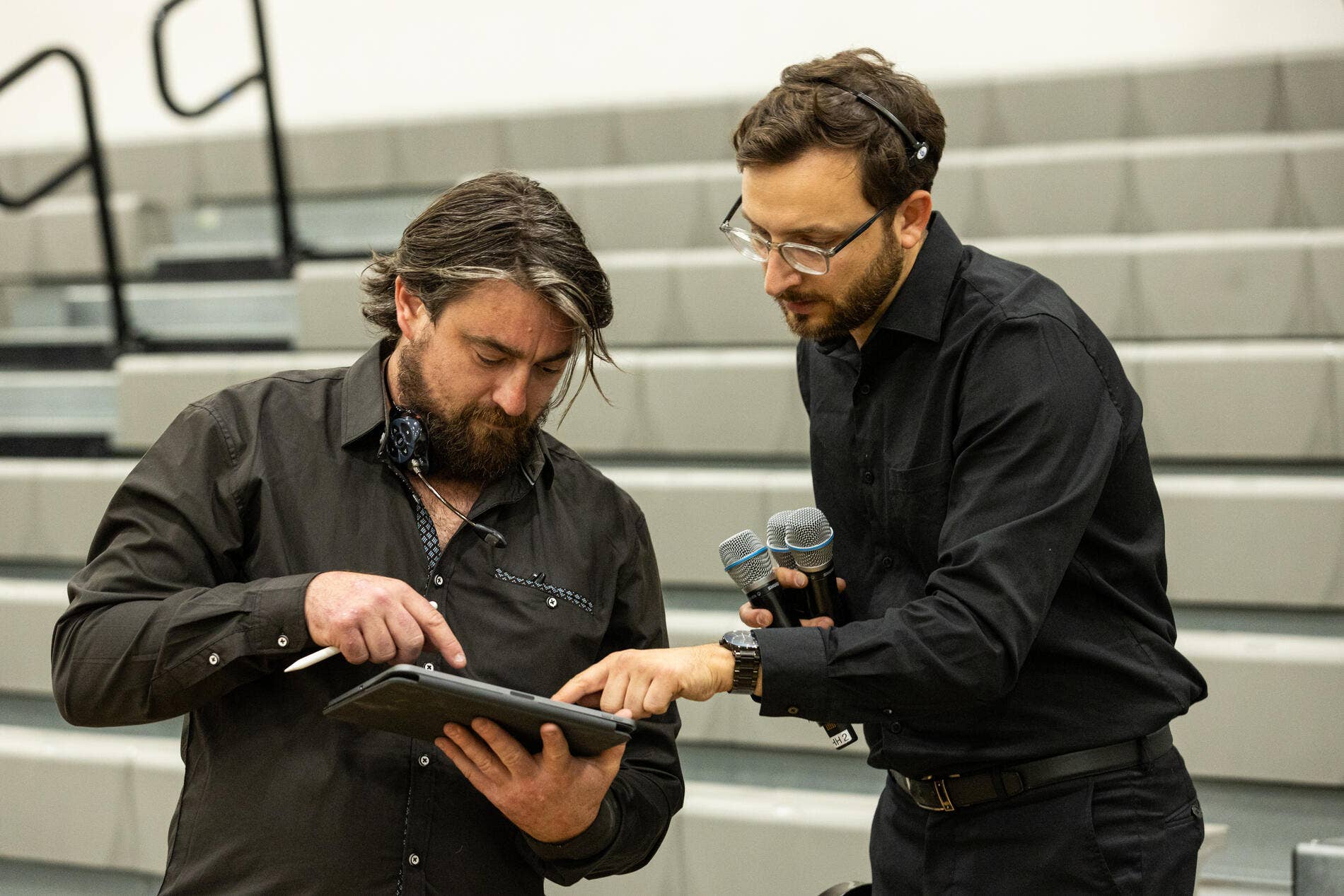 Two stagehands prepare for a concert.