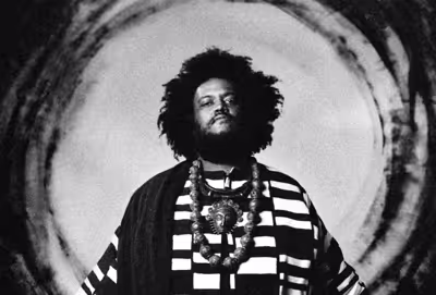 black and white photo of man in traditional garb