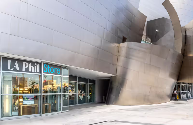 LA Phil Store entrance with glass storefront and modern metallic building wall in the foreground.